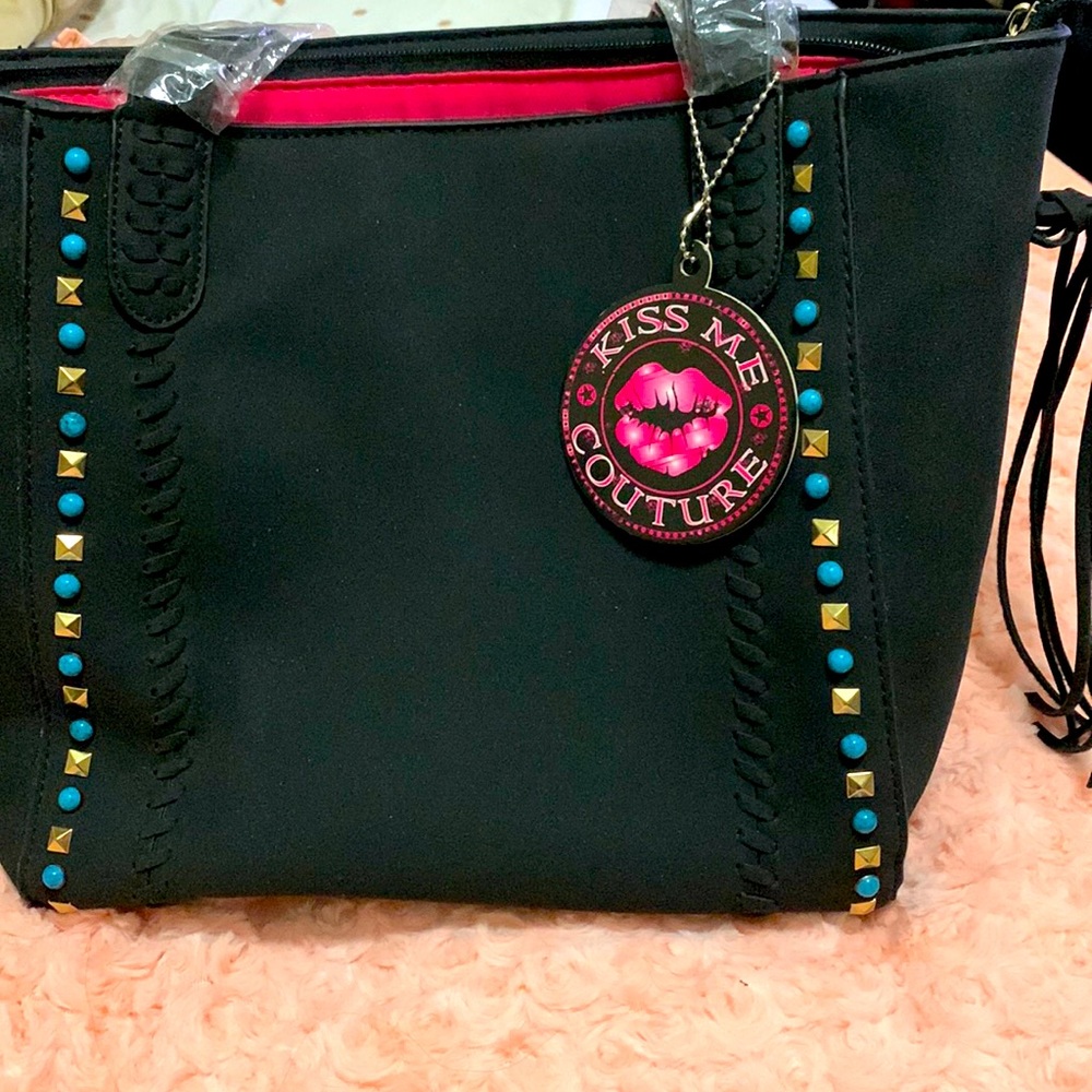 New black purse never used. It has a western feel to the purse.